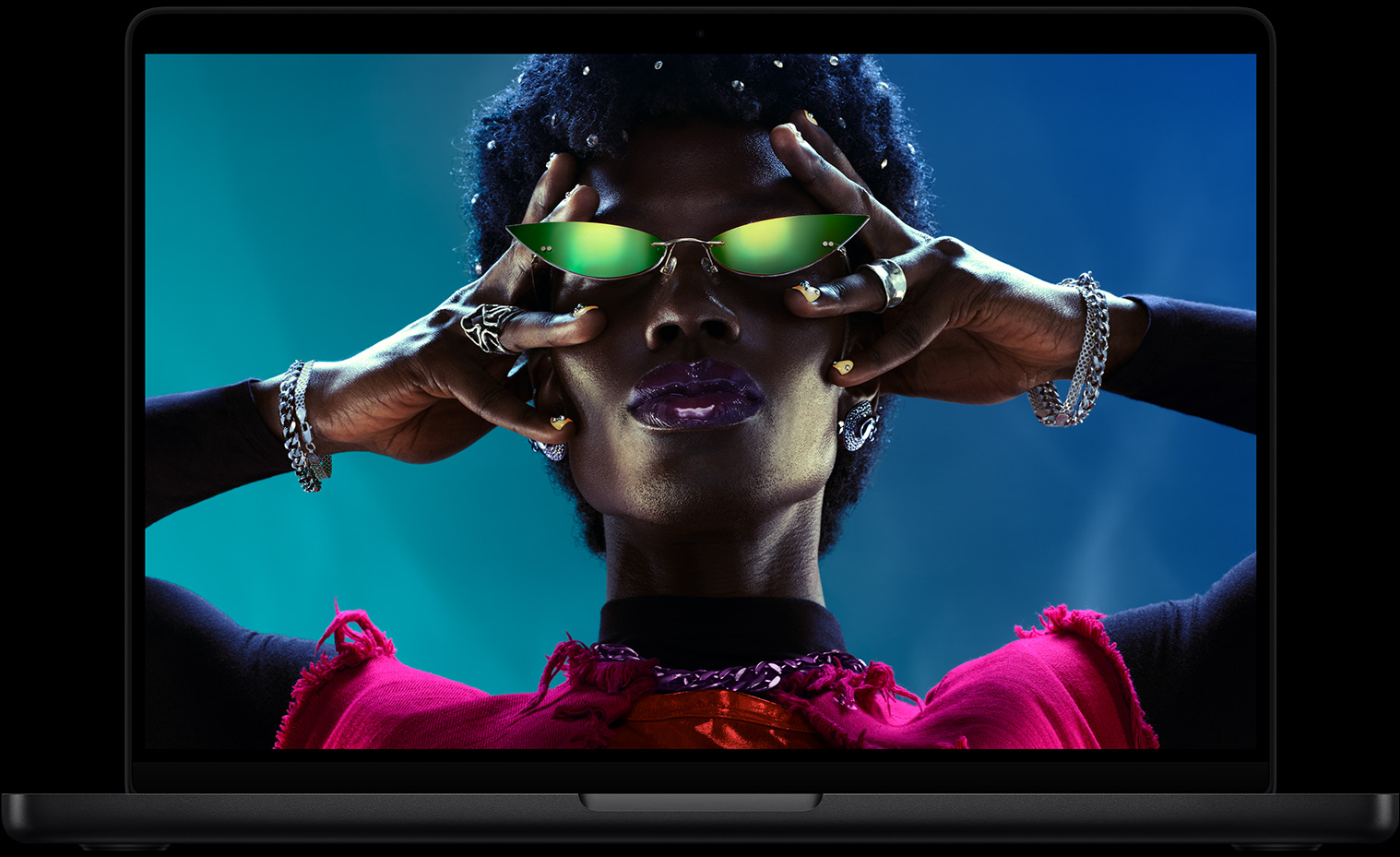 Colorful screen on a Macbook Pro of a person crowd-surfing at a party, showcasing the vibrant Liquid Retina XDR display