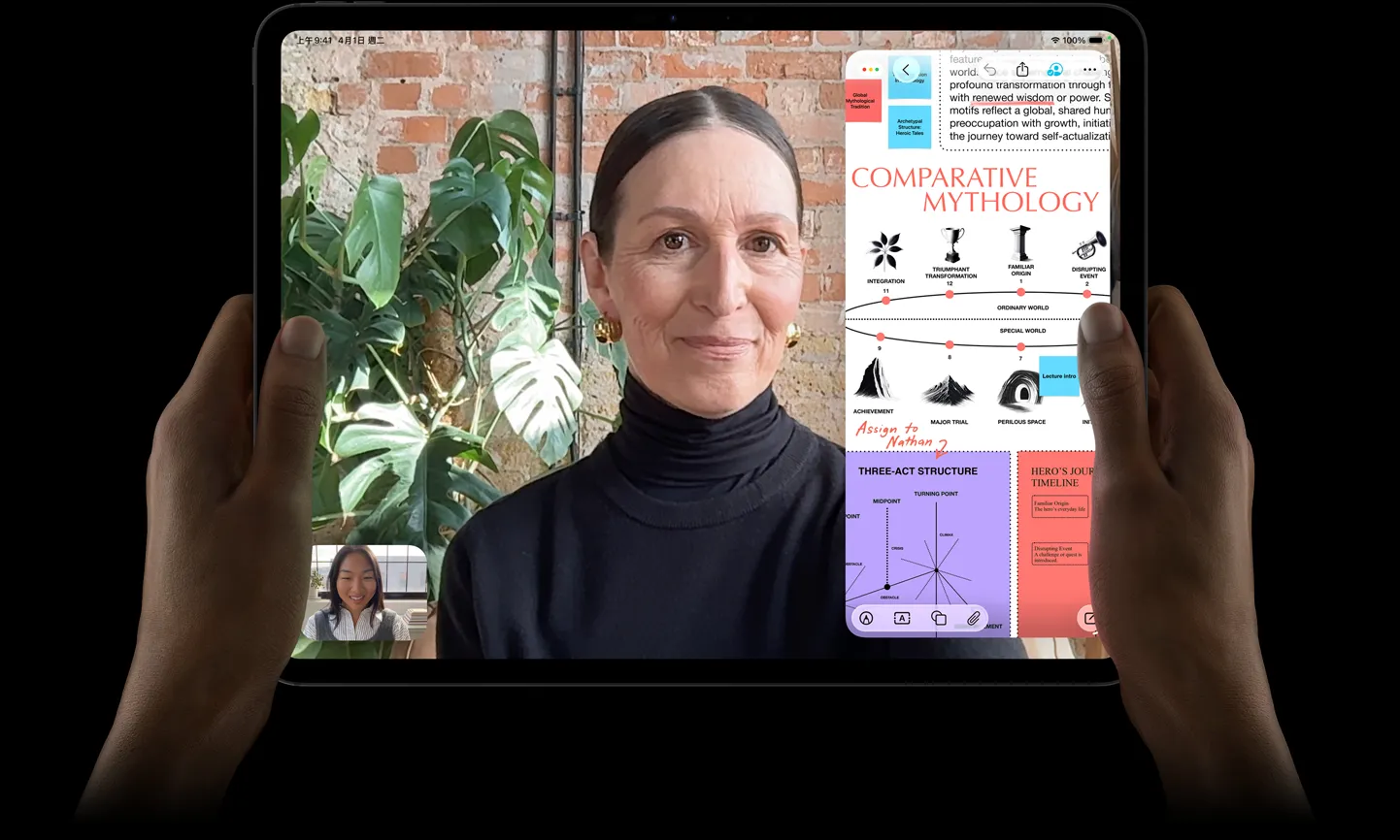 太空黑色 iPad Pro 機身正面，左右手以橫向拿著 iPad Pro，展示圓角設計與黑色顯示器邊框，顯示器展示正在即時翻譯 FaceTime 對話，以及展示 Comparative Mythology 簡報的教育 app，內含文字、圖表與手寫筆記