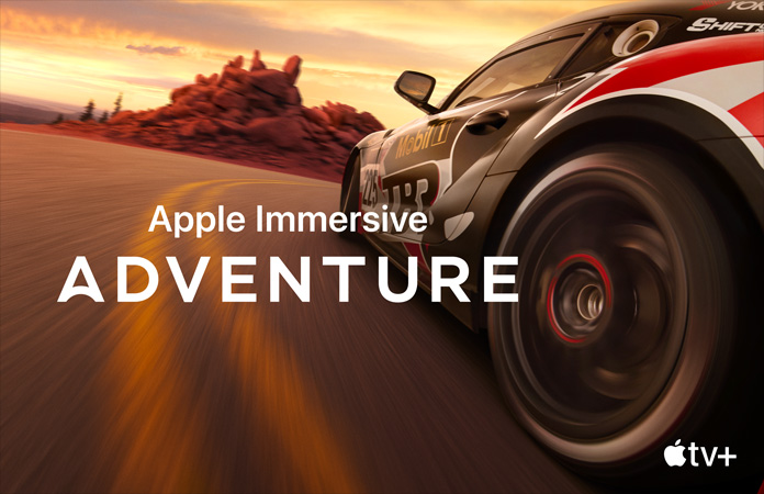 صورة لسيارة سباق مع جملة Apple Immersive Adventure بحروف بيضاء في الأعلى
