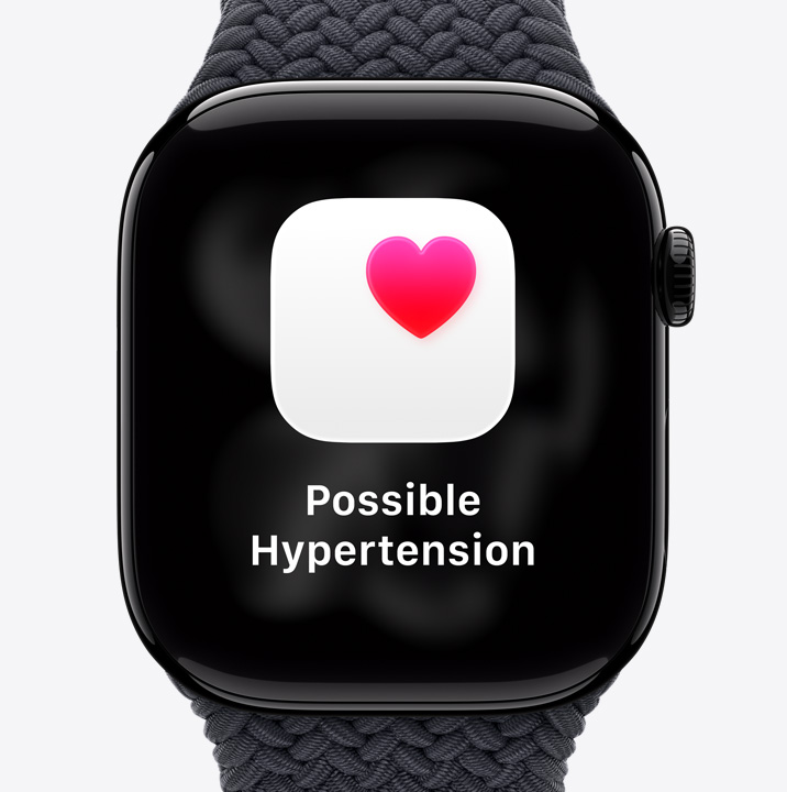 Apple Watch Series 11, aluminum case, polished Jet Black color, possible hypertension health notification, pink heart in white box, right side exterior, Digital Crown, Braided Solo Loop, black color